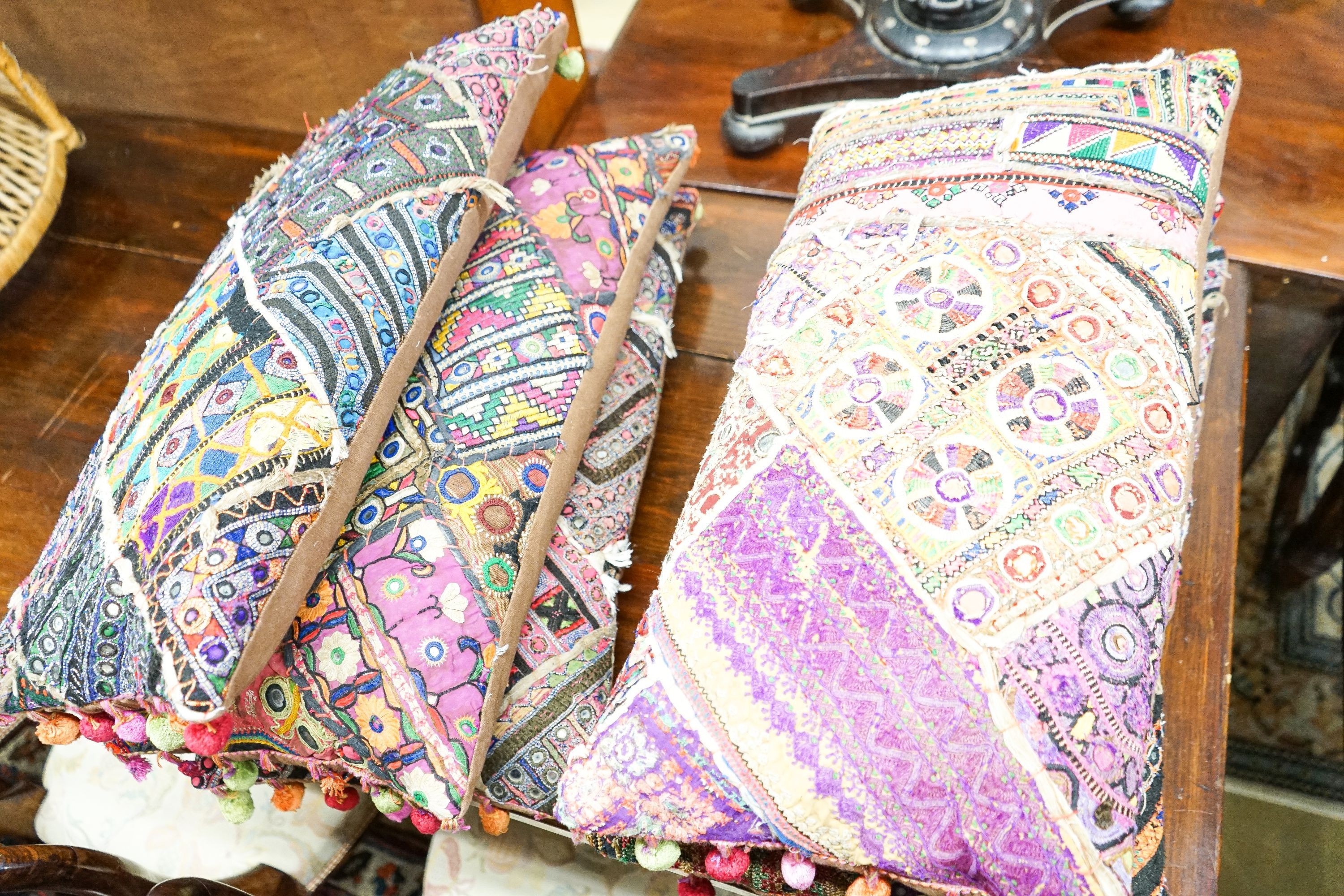 Eight Indian embroidered cushions, 60 x 30cm